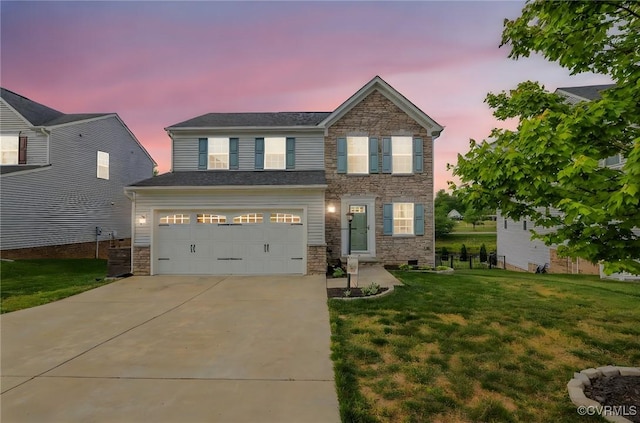view of front facade featuring a lawn, an attached garage, driveway, and stone siding