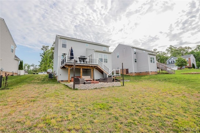 back of house with a wooden deck, a yard, and stairway