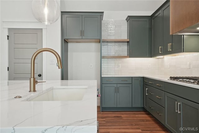 9088 Terroir Ln, New Kent, VA 23124 - kitchen with light stone counters, stainless steel gas cooktop, and backsplash