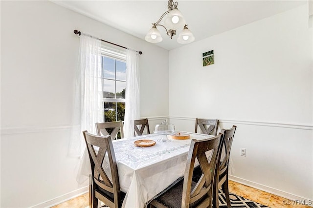 dining area featuring baseboards and light tile patterned floors