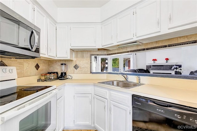 kitchen with white range with electric cooktop, a sink, white cabinets, stainless steel microwave, and black dishwasher