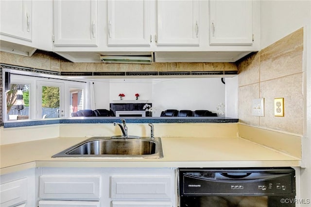 kitchen with a sink, light countertops, white cabinets, and dishwasher