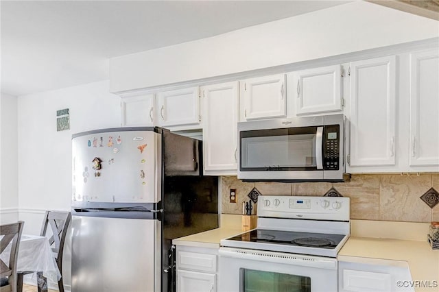 kitchen featuring light countertops, stainless steel appliances, white cabinetry, and decorative backsplash