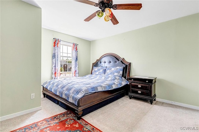 carpeted bedroom with a ceiling fan and baseboards