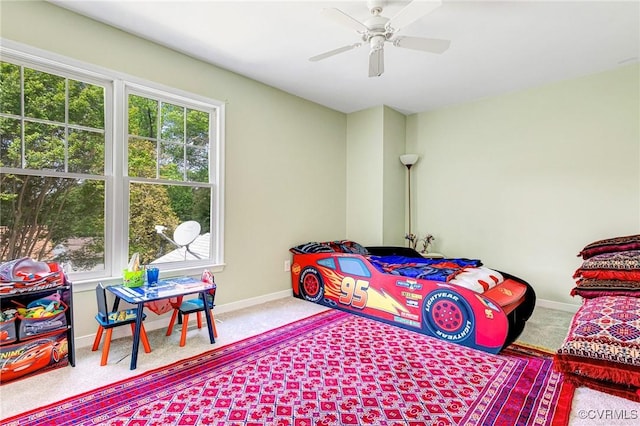 carpeted bedroom featuring a ceiling fan and baseboards