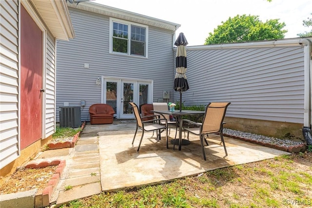 view of patio featuring cooling unit, french doors, and outdoor dining space