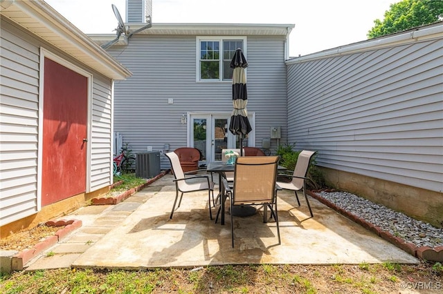 view of patio featuring central air condition unit, french doors, and outdoor dining space
