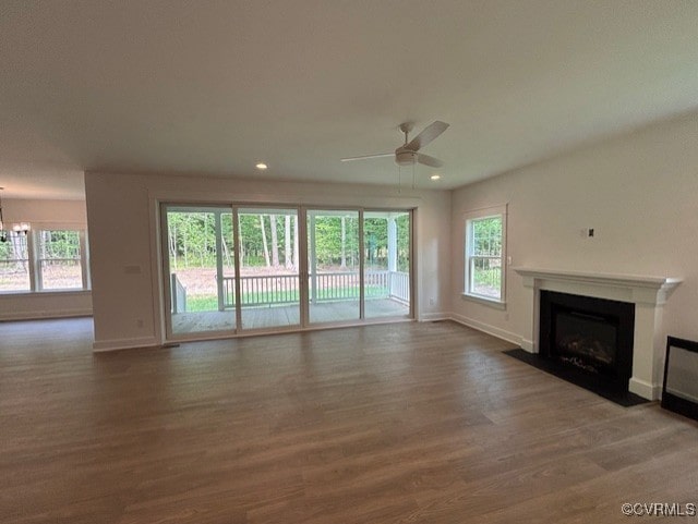 9107 Terroir Ln, New Kent, VA 23124 - unfurnished living room featuring a fireplace with flush hearth, wood finished floors, baseboards, healthy amount of natural light, and recessed lighting