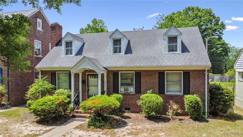 3410 Montrose Ave, Richmond, VA 23222 - new england style home with brick siding, cooling unit, and roof with shingles
