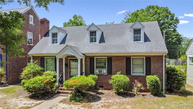 3410 Montrose Ave, Richmond, VA 23222 - new england style home with brick siding, cooling unit, and roof with shingles