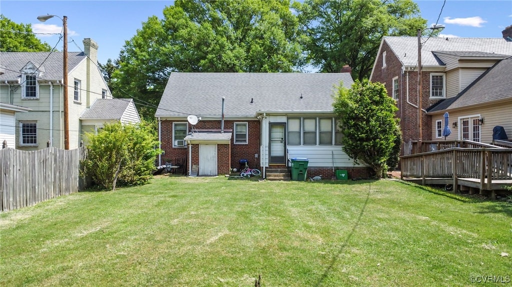 3410 Montrose Ave, Richmond, VA 23222 - rear view of house with fence, a deck, brick siding, entry steps, and a yard