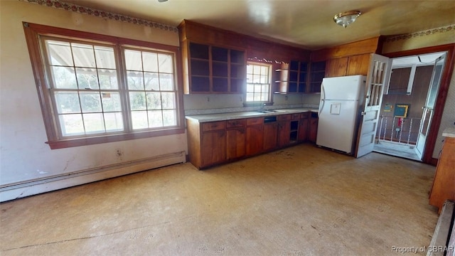 kitchen with open shelves, light countertops, brown cabinetry, freestanding refrigerator, and a baseboard radiator