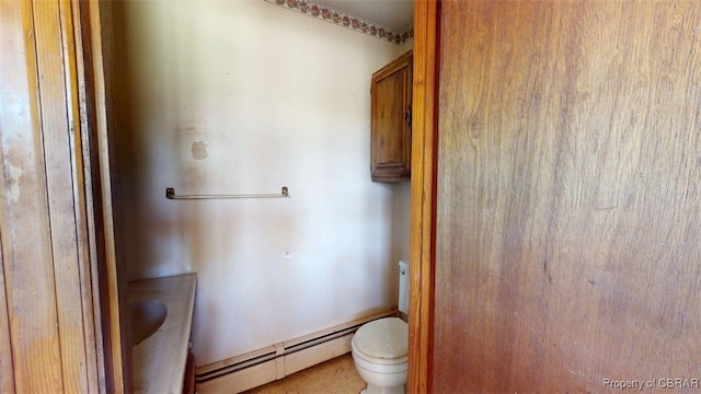 bathroom featuring a baseboard radiator and toilet