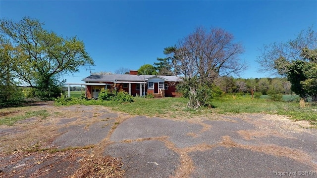 back of property with a chimney