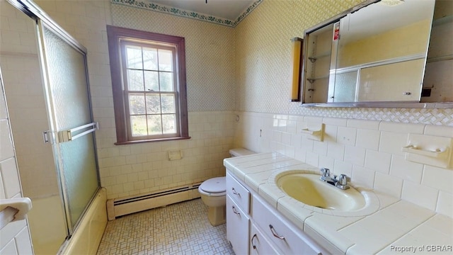 full bathroom featuring tile walls, a baseboard heating unit, tile patterned floors, and a wealth of natural light