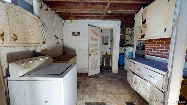 washroom featuring laundry area, washer / dryer, water heater, and electric panel