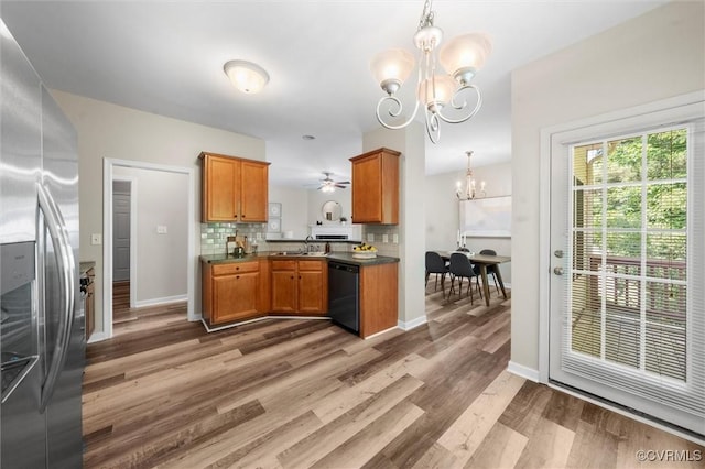 kitchen with stainless steel fridge, dishwasher, a chandelier, light wood finished floors, and brown cabinetry
