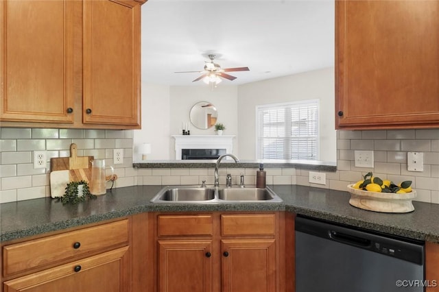 kitchen featuring stainless steel dishwasher, a sink, a ceiling fan, decorative backsplash, and dark countertops