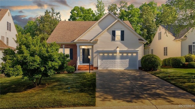 traditional-style house featuring driveway, a front lawn, a garage, and brick siding