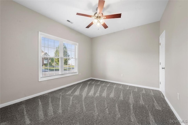 unfurnished room with dark carpet, baseboards, and a ceiling fan