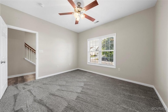 empty room featuring carpet floors, ceiling fan, and baseboards