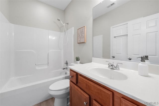 full bathroom featuring toilet, shower / bath combination, vanity, and wood finished floors