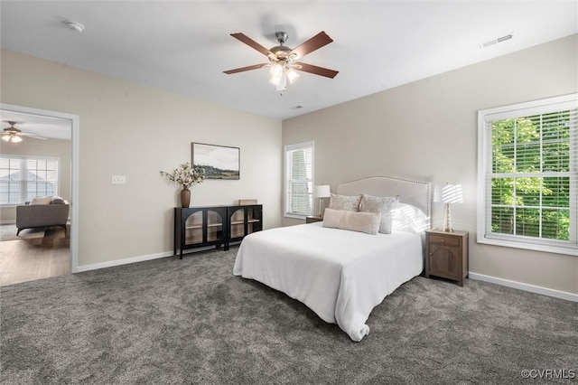 carpeted bedroom featuring baseboards and a ceiling fan