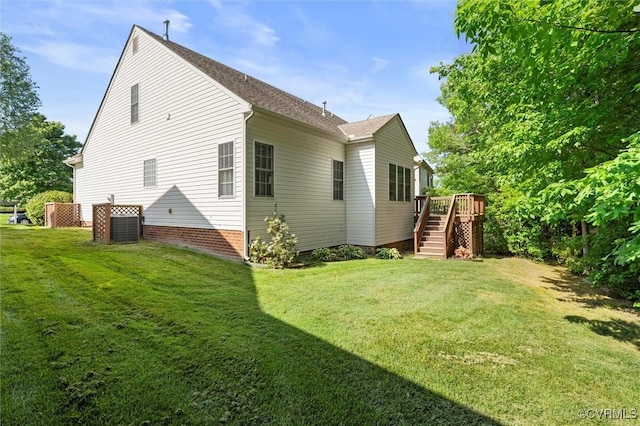 view of side of property with stairs, a deck, and a yard