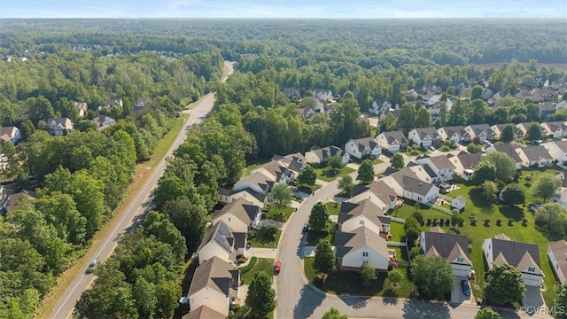 aerial perspective of suburban area featuring a forest