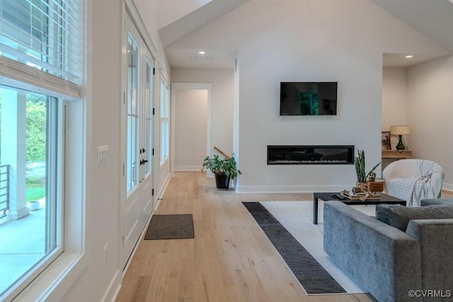 4629 Butte Rd, Richmond, VA 23235 - living room with wood finished floors, french doors, a glass covered fireplace, recessed lighting, and baseboards