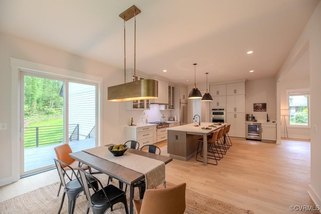 4629 Butte Rd, Richmond, VA 23235 - dining space with wine cooler, light wood-type flooring, recessed lighting, and baseboards