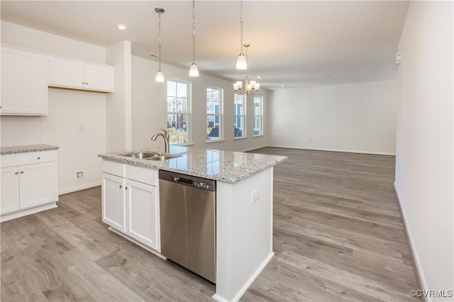 kitchen with stainless steel dishwasher, baseboards, a chandelier, white cabinets, and a sink