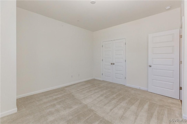 carpeted spare room with baseboards
