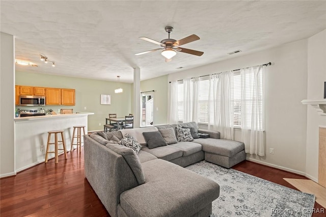 921 Hanson Dr, Newport News, VA 23602 - living area with a ceiling fan, visible vents, dark wood finished floors, a tile fireplace, and baseboards