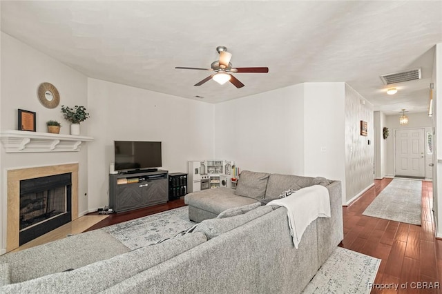 921 Hanson Dr, Newport News, VA 23602 - living room with a ceiling fan, dark wood-style flooring, visible vents, a fireplace with flush hearth, and baseboards