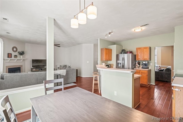 921 Hanson Dr, Newport News, VA 23602 - dining room with a fireplace, visible vents, and dark wood-type flooring
