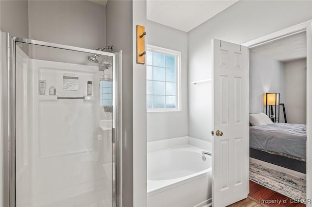 921 Hanson Dr, Newport News, VA 23602 - ensuite bathroom featuring ensuite bathroom, a stall shower, a garden tub, and wood finished floors