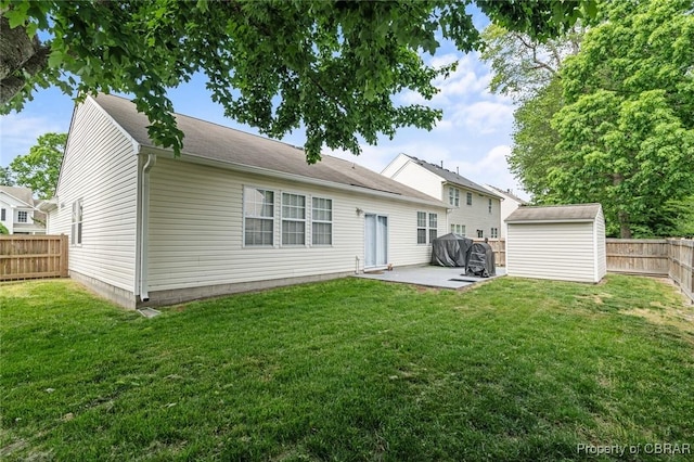 921 Hanson Dr, Newport News, VA 23602 - rear view of property featuring an outbuilding, a fenced backyard, a storage unit, a yard, and a patio