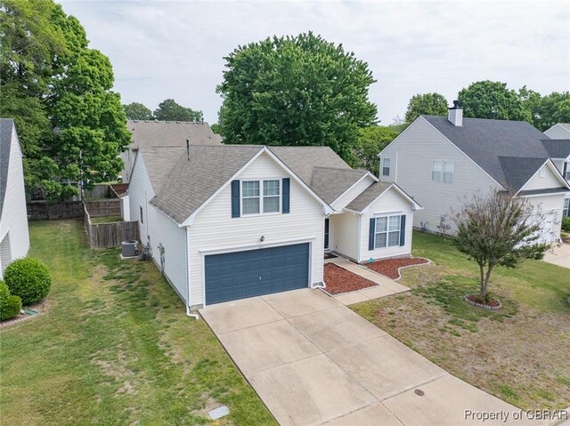 921 Hanson Dr, Newport News, VA 23602 - traditional home with a garage, a front lawn, central AC, fence, and driveway