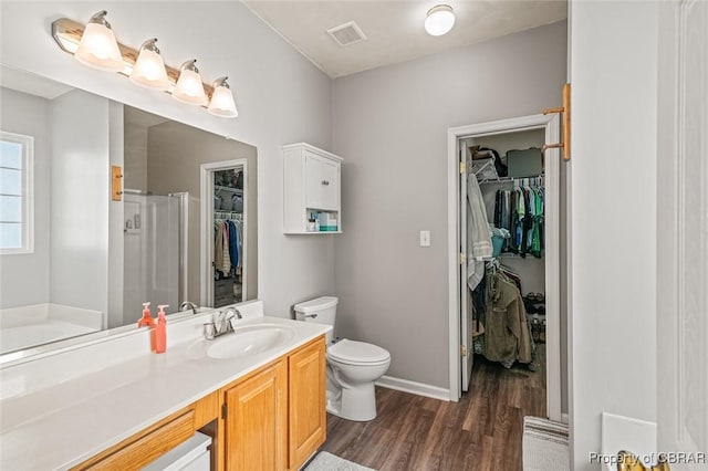 921 Hanson Dr, Newport News, VA 23602 - full bath with visible vents, wood finished floors, toilet, baseboards, and a stall shower