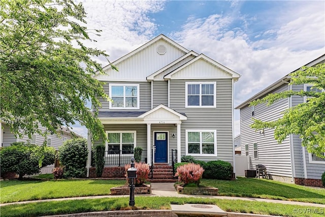 4716 Fulton St, Richmond, VA 23231 - view of front of home featuring board and batten siding, a porch, a front yard, and central AC