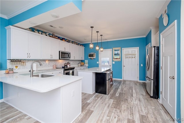4716 Fulton St, Richmond, VA 23231 - kitchen featuring stainless steel appliances, a sink, light countertops, a kitchen island, and a peninsula