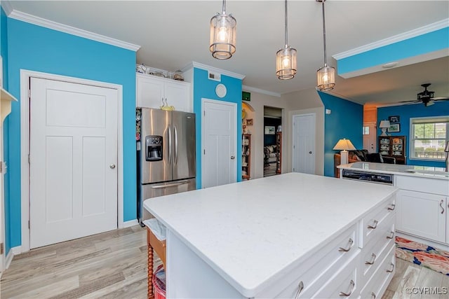 4716 Fulton St, Richmond, VA 23231 - kitchen featuring stainless steel fridge, light wood-style floors, ornamental molding, a kitchen island, and white cabinetry