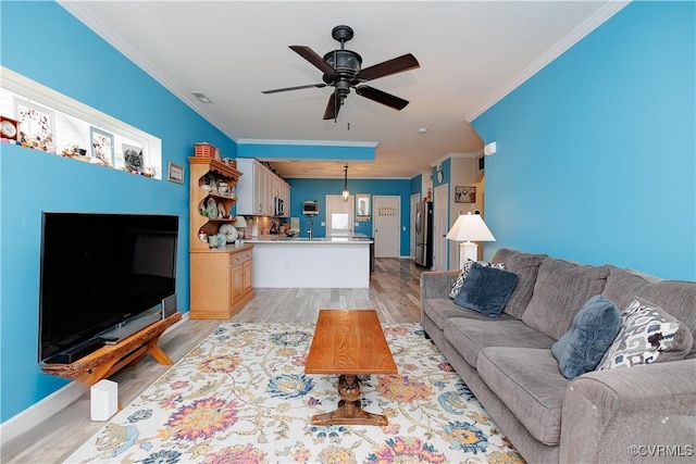 4716 Fulton St, Richmond, VA 23231 - living area featuring crown molding, light wood-type flooring, a ceiling fan, and baseboards
