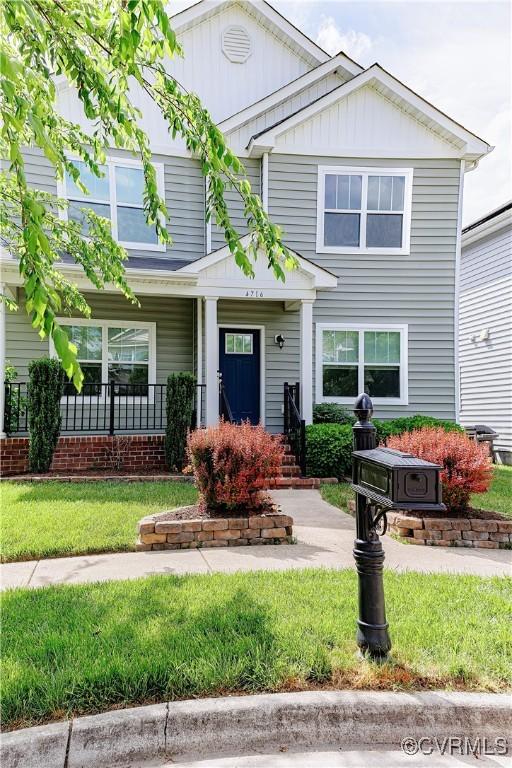 4716 Fulton St, Richmond, VA 23231 - view of front facade featuring a front lawn, covered porch, and board and batten siding