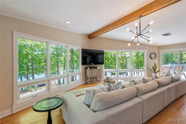 living area featuring a chandelier, beam ceiling, visible vents, and wood finished floors