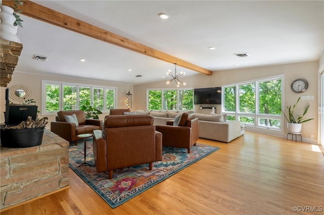living room with plenty of natural light, beam ceiling, and visible vents
