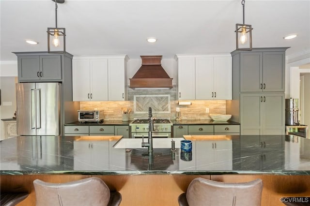 kitchen featuring recessed lighting, premium appliances, and custom range hood