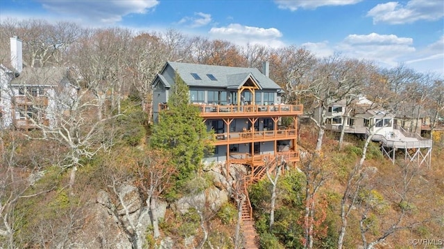 380 Blackrock Cir, Wintergreen, VA 22967 - back of house featuring a deck, view of wooded area, and a shingled roof