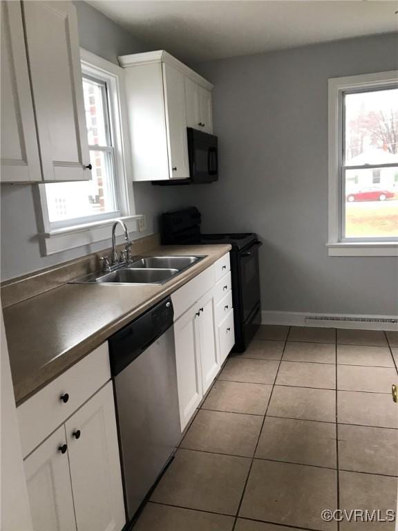 kitchen with white cabinetry, light tile patterned floors, a sink, and black appliances